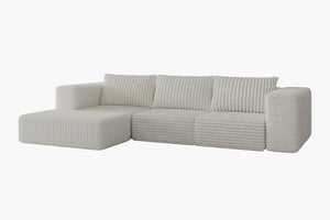 The Atlas Modular Sofa by Acanva is a contemporary white sectional with ribbed upholstery, featuring three back cushions and an extended left-side chaise, all set against a simple white background.