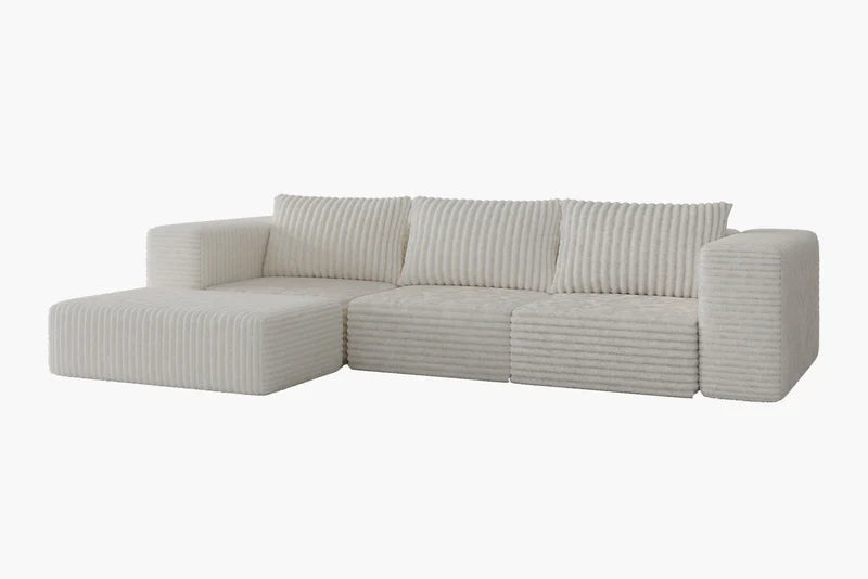The Atlas Modular Sofa by Acanva is a contemporary white sectional with ribbed upholstery, featuring three back cushions and an extended left-side chaise, all set against a simple white background.
