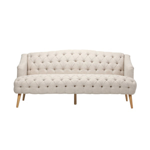 The Comfy 3 Seat Sofa features a beige, tufted design with wooden legs, three cushions, and a curved backrest. Its classic button-tufting across the seat and back adds an elegant touch to any living room or study.