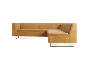 The Bonnie and Clyde Sectional Sofa is a modern L-shaped piece, crafted from tan leather with sleek black metal legs. It boasts a minimalist design and a comfortable backrest, showcased against a plain white background.