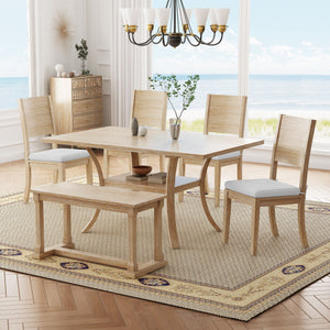 A dining room featuring the Topmax 6 Piece Wood Dining Table Set with a table, bench, and four cushioned chairs on a patterned rug. A sideboard with decor lines the wall, while a chandelier hangs above. Large windows frame a beach view.