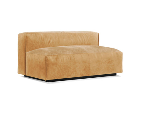 The Cleon Modern Unarmed Sofa is a tan leather piece with a wide seat and backrest, showcasing a minimalist design. It features a floating appearance due to its lack of visible legs and rests on a black base, making it perfect for a contemporary interior setting.