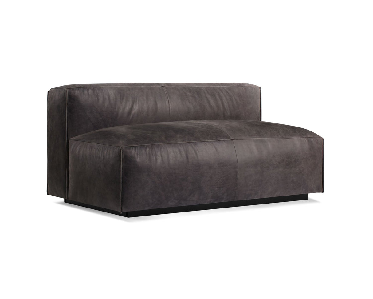 The Cleon Modern Unarmed Sofa features a minimalist design with clean lines, showcasing dark gray leather upholstery on a black base.
