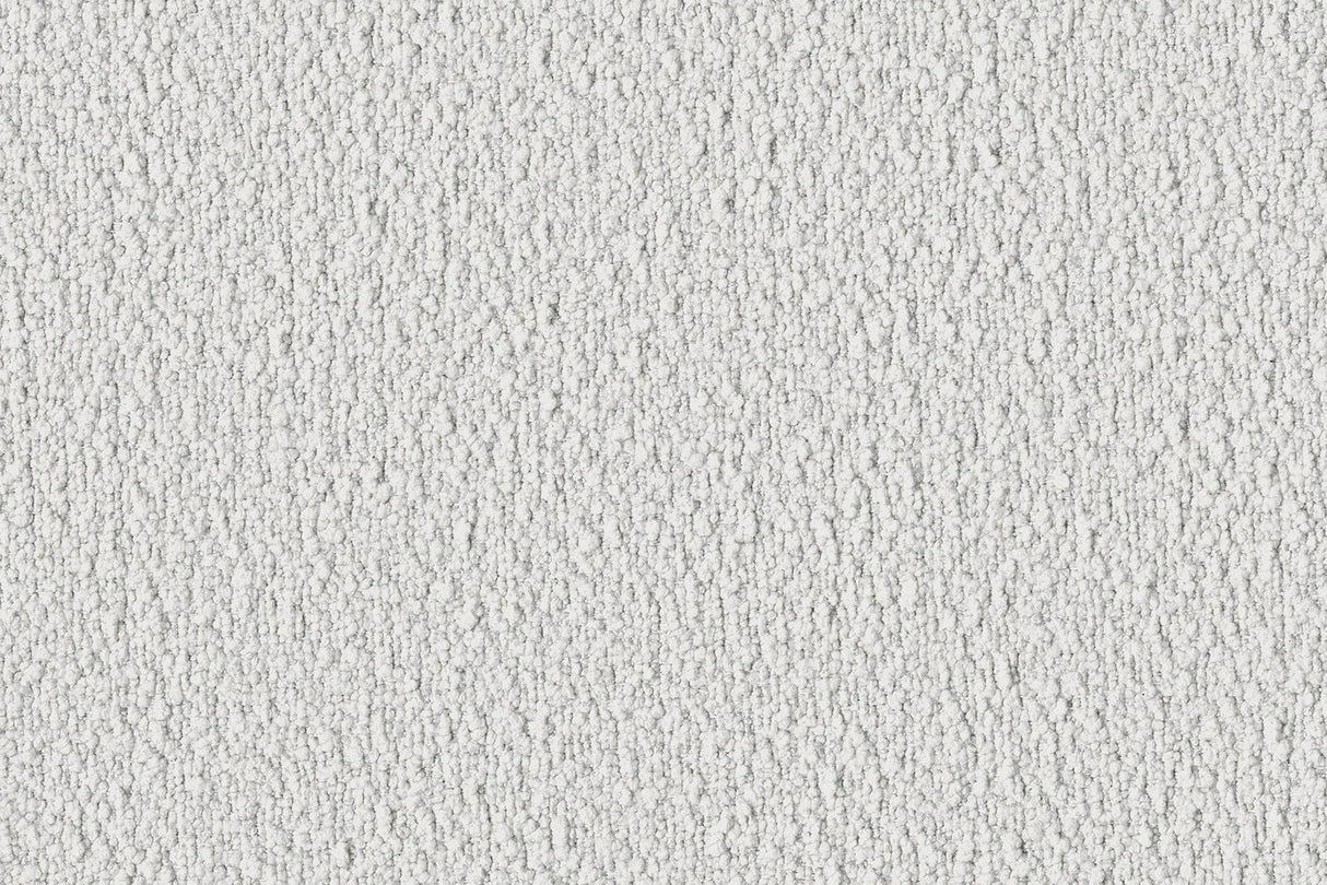 Close-up of the Dori Sofa by Acanva, showcasing its textured white fabric, featuring a rough, irregular pattern with small shadows creating a dappled effect. The surface appears slightly grainy, giving it a tactile, rustic appearance.