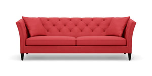 The Shelton 98" Sofa features a red color with a tufted backrest and two seat cushions, along with stylish flare arms. It rests on dark wooden legs and embodies a modern, elegant design.