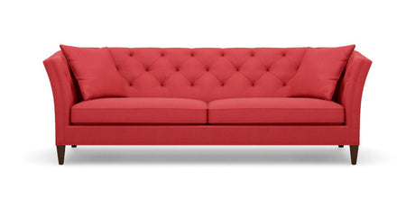 Introducing the Shelton 98" Sofa: a contemporary red sofa featuring a tufted backrest and two seat cushions. It showcases angled armrests, rests on four dark wooden legs, and comes complete with two coordinating red throw pillows at each end.