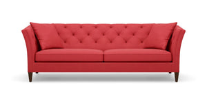 Introducing the Shelton 98" Sofa: a contemporary red sofa featuring a tufted backrest and two seat cushions. It showcases angled armrests, rests on four dark wooden legs, and comes complete with two coordinating red throw pillows at each end.