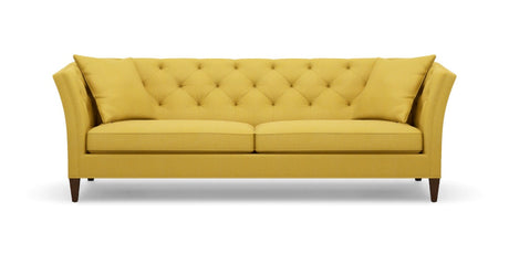 The Shelton 98" Sofa features a mustard yellow tufted design with two seat cushions and two back cushions. It has high arms and dark wooden legs, all set against a plain white background.