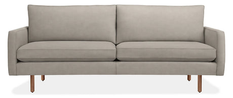 Introducing the 86" Jasper Sofa, a modern piece in light gray, featuring two seat cushions and two back cushions. It boasts slim armrests and stands on four wooden legs, embodying a minimalist and contemporary design.