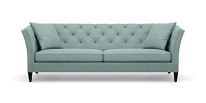The Shelton 98" Sofa is teal with a tufted backrest and angled arms, featuring two seat cushions and four tapered black legs.