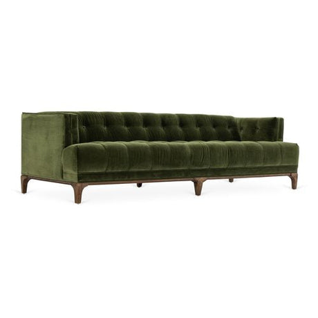 The Caledonia Sofa in Sapphire Olive Velvet features a tufted design with wooden legs, complemented by a low backrest and armrests. Its modern and elegant appearance makes it ideal for a contemporary living room.