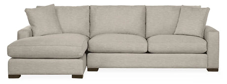 The Metro Sofas with Chaise is a light gray sectional featuring a left-side chaise lounge, modern design, three back cushions, and square armrests. It sits on short, dark wooden legs for an elevated look.