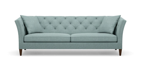 The Shelton 98" Sofa boasts a light teal color with tufted upholstery, featuring an angled backrest and cushions. Its wooden legs and contemporary design offer a stylish and comfortable two-seat seating option.