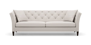 The Shelton 98" Sofa is a modern, light gray piece with a tufted backrest and includes two matching cushions. It showcases a symmetrical design enhanced by flared arms and sits on dark wooden legs.