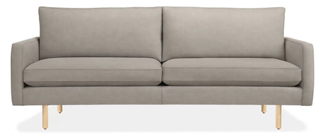 The 86" Jasper Sofa is a modern piece in grey with sleek, straight lines and wooden legs. It includes two large backrest cushions and two seat cushions, presenting a minimalist and contemporary design.