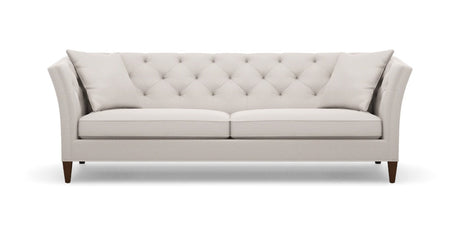 The Shelton 98" Sofa features a light gray, tufted back design with two square cushions. It showcases clean lines and tapered wooden legs, offering a modern and elegant aesthetic against a white background.