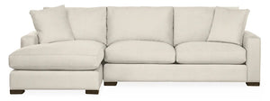 The Metro Sofas with Chaise is a light beige, L-shaped sectional sofa featuring plush cushions, a left-side chaise, and dark wooden legs, all showcased against a plain white background.