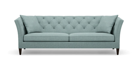 The Shelton 98" Sofa is a stylish piece, featuring a tufted backrest and two seat cushions in a chic teal color. It boasts flared armrests and rests on dark wooden legs, seamlessly combining contemporary design with comfort.