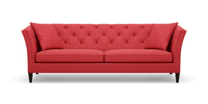 Introducing the Shelton 98" Sofa: a stunning red tufted design complete with two cushions, flared arms, and dark wooden legs, all showcased against a plain white background.