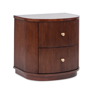 The Valentine - 2 Drawer Storage Side Table is a dark wood, semi-circular nightstand with vertical ribbed texture and gold knobs, set against a white background.