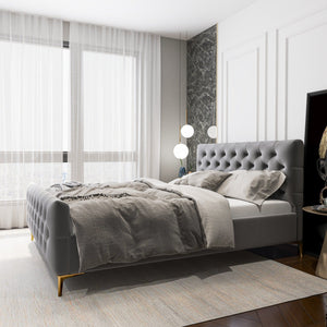 A modern bedroom features the Bailey - Elegant Design Bed with grey bedding. Large windows bring in sunlight, softened by sheer white curtains. The setting is serene, with a textured grey accent wall and minimalist decor enhancing the tranquil vibe.
