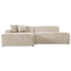 The Mar sectional sofa is a modern, light beige piece featuring a left chaise and two throw pillows, upholstered in soft textured fabric. With minimalist design, clean lines, and a low profile, it stands out beautifully against a white background.