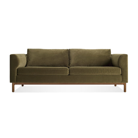 Guide 82" Sofa in moss velvet with plush cushions, wide armrests, and a walnut base, shown from the front against a white background.