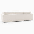 The Harmony Modular 3 Piece Sofa, featuring a large and modern white sectional design with minimalist aesthetics and low cushions, is showcased against a plain white background. This sofa comprises three interconnected segments, offering a sleek and contemporary look.