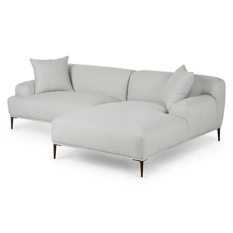 The Abisko 94.5 Right Sectional Aurora Blue is a contemporary sectional sofa in a modern design, featuring a chaise lounge on one side and two large cushions. Its sleek metal legs and light gray color make it an ideal choice for contemporary interiors.