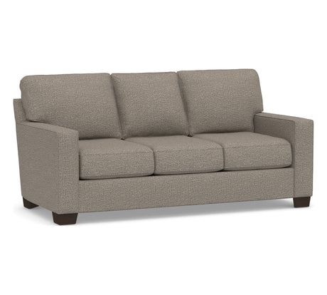 The Buchanan Square Arm Sleeper Sofa is a beige three-seater with textured fabric upholstery, featuring rectangular armrests and dark wooden legs, set against a plain white background.