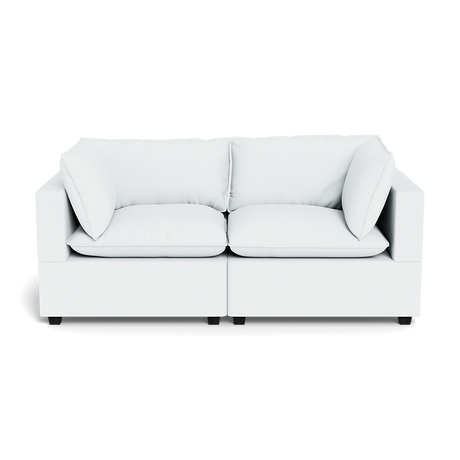 The Kova Pillow Cushion Sofa 86" is a modern white sofa featuring two seat cushions, two back cushions, and four side pillows, shown from the front against a black background.