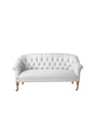 The Paxton Tufted Loveseat, featuring a white tufted design with rounded arms and wooden legs, including front wheels, is displayed against a plain white background.