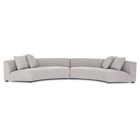 The Zoe Modern White Performance Black Birch Wood Piece Curved Sectional is a contemporary design in light gray, featuring two spacious sections that are joined together. Each section includes backrest cushions and additional throw pillows for enhanced comfort.