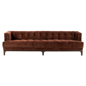 A long green mid-century velvet sofa with button tufting and a low brown wooden frame. The design is modern, featuring straight arms and a boxy shape, making it suitable for contemporary living rooms.
