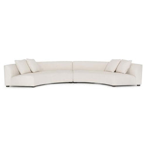 Introducing the Zoe Modern White Performance Black Birch Wood Piece Curved Sectional: a spacious and contemporary sofa featuring three seat cushions and four square pillows. Its low-backed design offers a sleek, minimalist style, making it an ideal addition to modern interiors.