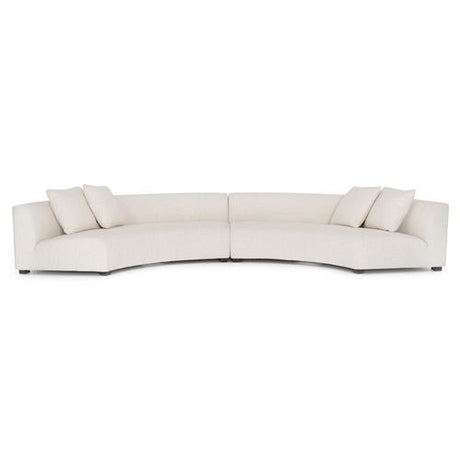 Introducing the Zoe Modern White Performance Black Birch Wood Piece Curved Sectional: a spacious and contemporary sofa featuring three seat cushions and four square pillows. Its low-backed design offers a sleek, minimalist style, making it an ideal addition to modern interiors.