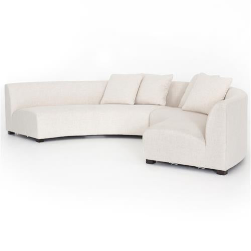 Introducing the Zoe Modern White Performance Black Birch Wood Piece Curved Sectional: a contemporary, curved sectional in beige hues, complemented by three matching cushions. This design showcases a sleek, minimalist aesthetic, featuring a low profile and plush seating on a white background.