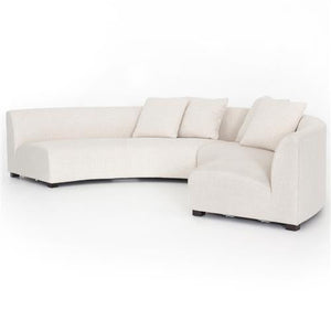 Introducing the Zoe Modern White Performance Black Birch Wood Piece Curved Sectional: a contemporary, curved sectional in beige hues, complemented by three matching cushions. This design showcases a sleek, minimalist aesthetic, featuring a low profile and plush seating on a white background.