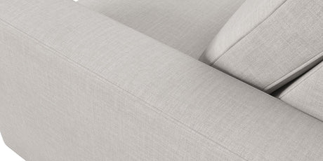 Close-up of the Rio Sofa, showcasing its light gray fabric with clean lines and visible stitching. The image highlights the armrest and backrest, emphasizing the texture and minimalist design of its upholstery.