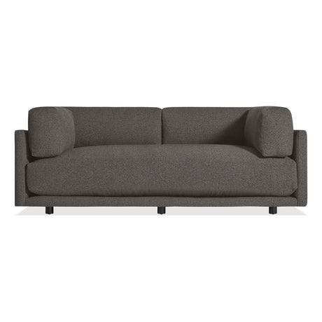 The Sunday 82" Sofa in Kelso Charcoal features a modern design with dark gray upholstery, clean lines, low arms, and short black legs, shown against a white background.