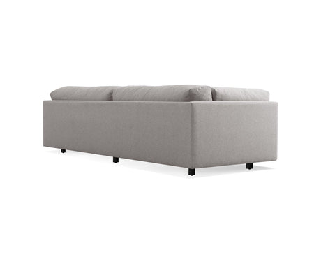 The Sunday 102-Inch Sofa is a contemporary, minimalist piece featuring a straight backrest and cushioned seating. Its design is elevated by small black legs, presenting a simple elegance ideal for modern interior spaces.