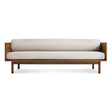 The Souvenir Sofa in Landa Stone with a walnut frame features minimalist design, clean lines, and light beige cushions, displayed against a plain white background.