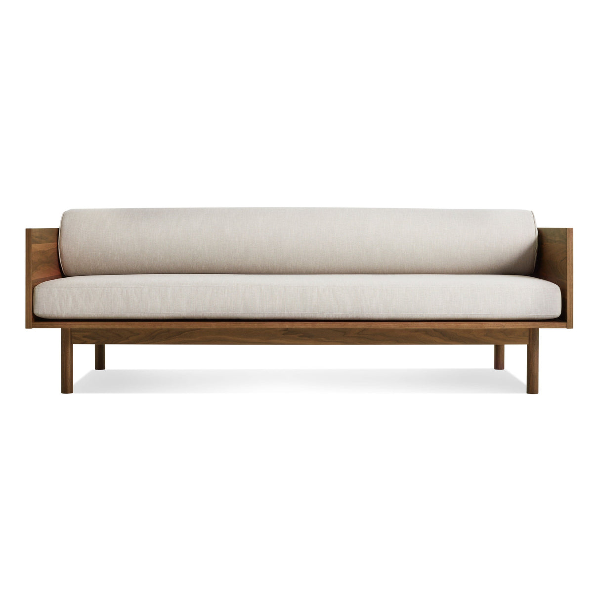 The Souvenir Sofa in Landa Stone with a walnut frame features minimalist design, clean lines, and light beige cushions, displayed against a plain white background.