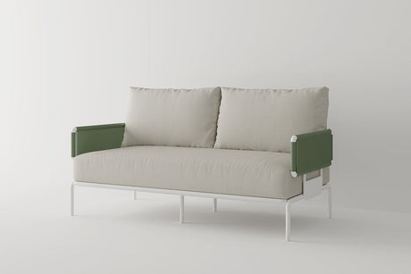 Introducing the Sylva Outdoor Modular Sofa by Acanva: a modern piece with a minimalist design, boasting beige upholstered seat and back cushions. This sofa features green, textured armrests and a sleek white metal frame, all set against a plain, light-colored background.