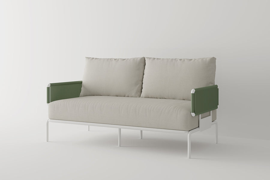 Introducing the Sylva Outdoor Modular Sofa by Acanva: a modern piece with a minimalist design, boasting beige upholstered seat and back cushions. This sofa features green, textured armrests and a sleek white metal frame, all set against a plain, light-colored background.