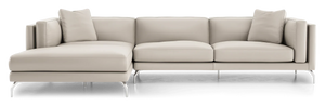 The Reade Sectional Sofa is a contemporary beige piece featuring sleek lines, metal legs, and three cushions. The chaise lounge extends to the left, offering a spacious seating arrangement.