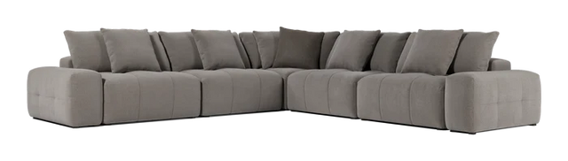 The Fullerton Modular Sofa 04 is a large, gray sectional sofa that offers plush cushions. It is configured in an L-shape and showcases a modern, minimalistic design with deep seating and broad armrests.