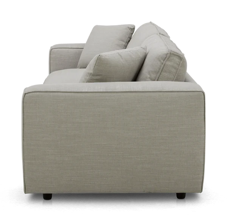 Side view of the Elmore Sofa in light gray fabric, featuring two seat cushions and two back cushions. The modern design rests on low, dark feet.