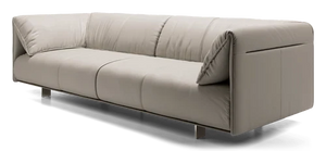 Introducing the Essex Sofa: a minimalist piece in light beige leather, boasting a sleek, modern design with thin metallic legs. It features three cushions and a low backrest for a comfortable seating experience.