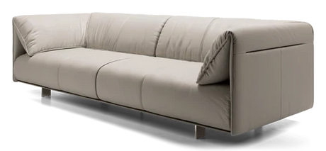 Introducing the Essex Sofa: a minimalist piece in light beige leather, boasting a sleek, modern design with thin metallic legs. It features three cushions and a low backrest for a comfortable seating experience.